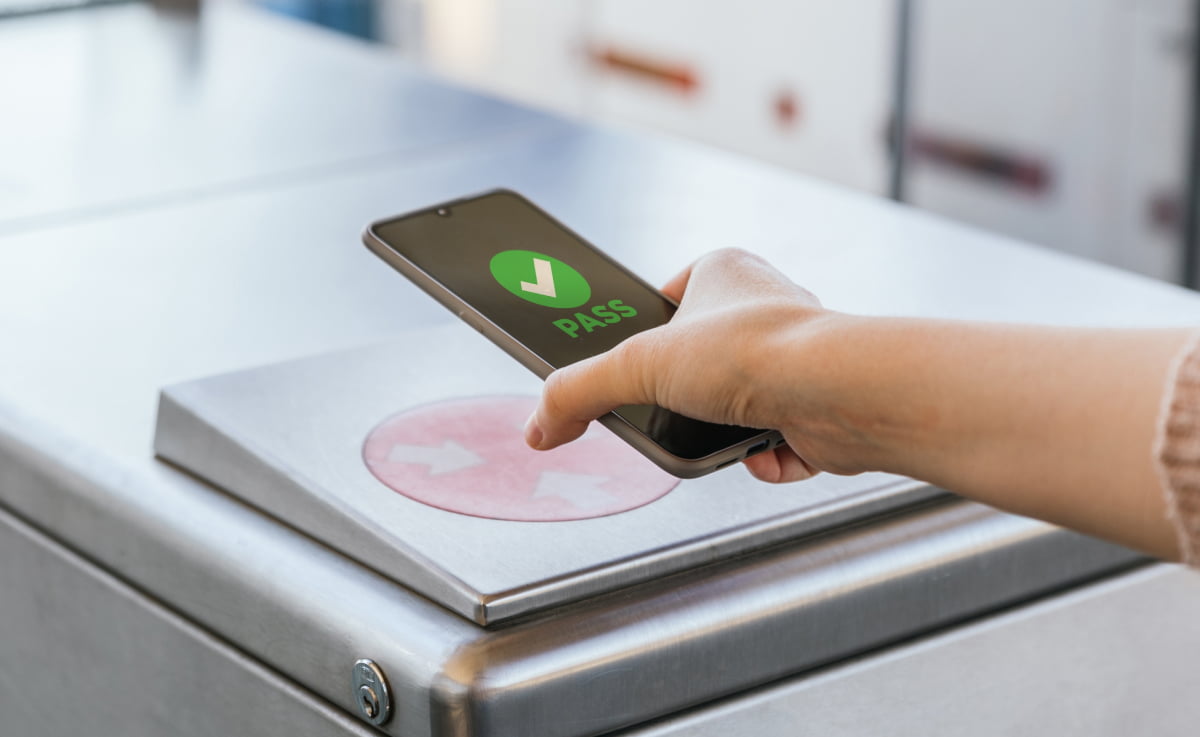 Image of a person scanning a NFC tag at an event entrance, representing the trend of digital ticketing in the ticketing industry for 2023